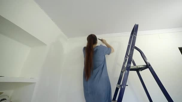A Middle Aged Woman Measures The Canvas For The Installation Of A Stretch Ceiling