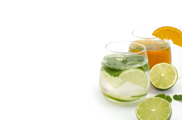 Glasses with citrus cocktails are on a white background