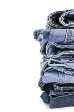 Beyaz arka plan denim mavi kot yığını. Giysi, moda, hayır severlik