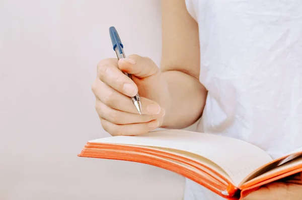 Woman Hands Holding Pen Red Notepad White Background — Stock Photo, Image