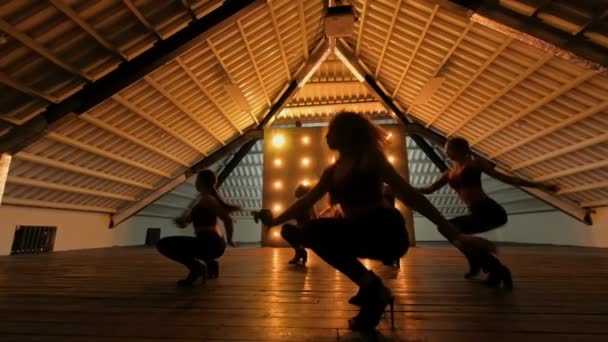 Σιλουέτες χορό κοριτσιών. Go-Go dance. Παράσταση χορού closeup της αρκετά γυναικείας ομάδας σε μια σκοτεινή σκηνή με κίτρινα φώτα. ομάδα χορού των γυναικών σε ψηλά τακούνια — Αρχείο Βίντεο