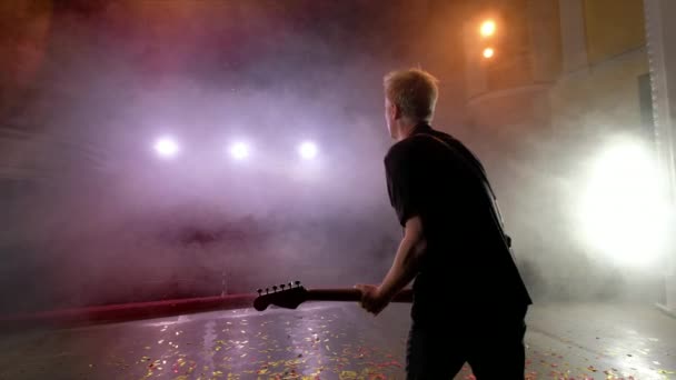 Гітарист виступає на сцені. Сценічне світло, дим . — стокове відео