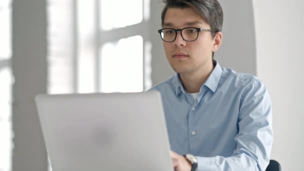 Estudiante universitario masculino mirando la pantalla del ordenador portátil pensativamente mientras hace la tarea. Primer plano del niño concentrado tratando de cumplir una tarea difícil mientras estudia — Vídeo de stock