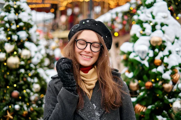 Close-up portrait of happy girl in beret enjoying winter moments. Outdoor photo of long-haired laughing lady in glasses having fun in snowy morning on blur nature background. — Stock Photo, Image