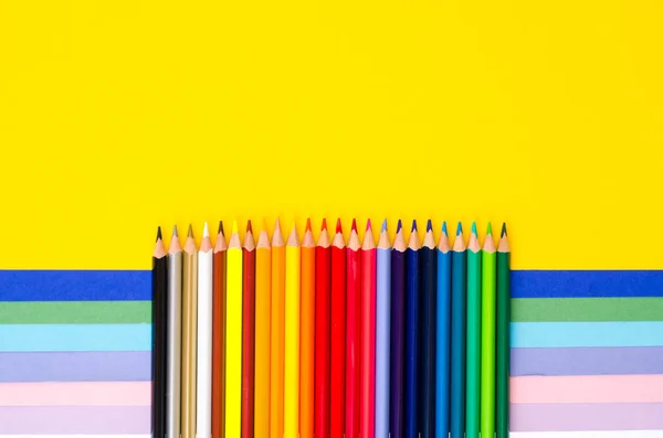 Set of colored pencils for schoolboy on bright background — Stock Photo, Image