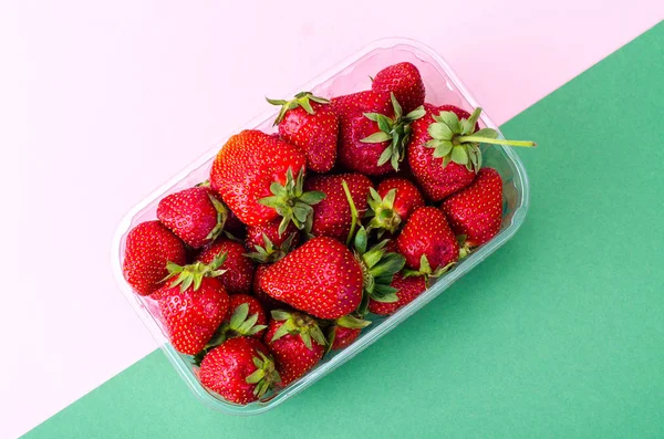 Plastic container with fresh strawberries — Stock Photo, Image