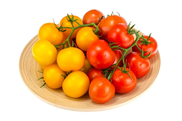 Ripe juicy tomatoes on large wooden plate — Stock Photo, Image