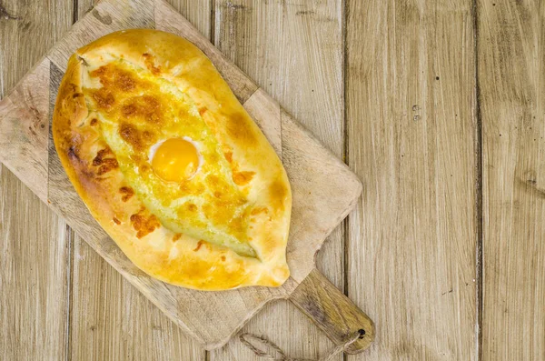 Khachapuri chaud au fromage et oeuf sur planche de bois — Photo