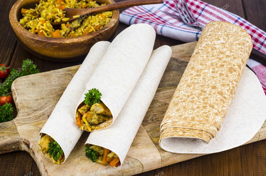 Fast street food. Lavash, shavarma with rice, chicken and vegetables