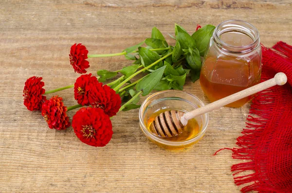 Garden flowers, honey and herbal tea on wooden background — Stock Photo, Image