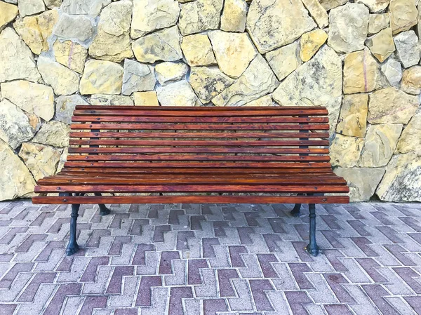 Vintage wooden bench on stone background — Stock Photo, Image