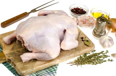 Çiğ tavuk eti üzerinde kesme tahtası, baharat ve sebzeler ile hazırlanan yemek için beyaz arka plan. Studio fotoğraf