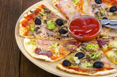 Altı dilim pizza ahşap tahta üzerinde farklı Topingler ile. Studio fotoğraf