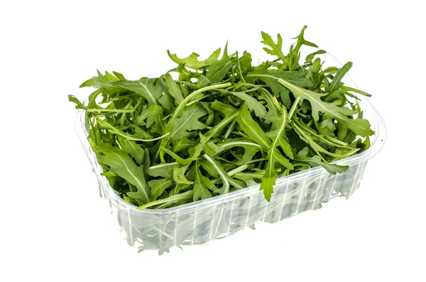 Beyaz arka plan üzerinde izole paket içinde taze yeşil roka. Studio fotoğraf