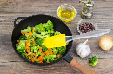 Vejetaryen yemek. Brokoli, havuç, tavada yeşil bezelye. Studio fotoğraf