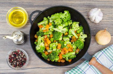 Vejetaryen yemek. Brokoli, havuç, tavada yeşil bezelye. Studio fotoğraf