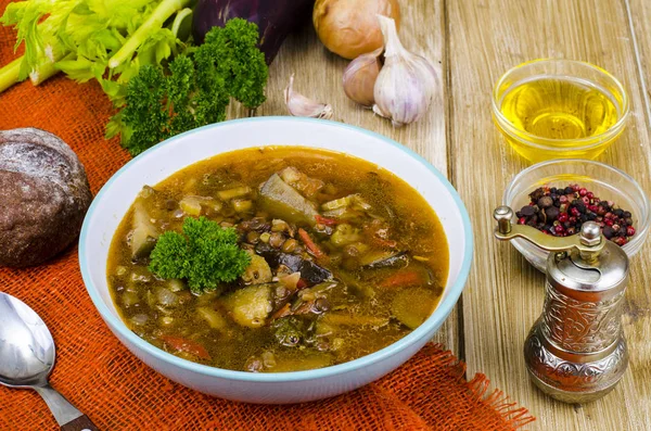 Hot vegetable soup with eggplants and lentils. Studio Photo