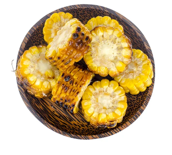 Slices of grilled corn on wooden plate — Stock Photo, Image