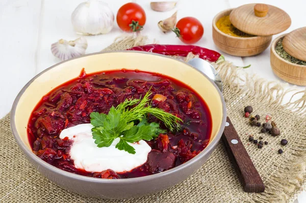 Delicious hot vegetable soup with beetroot, Russian borscht. Studio Photo