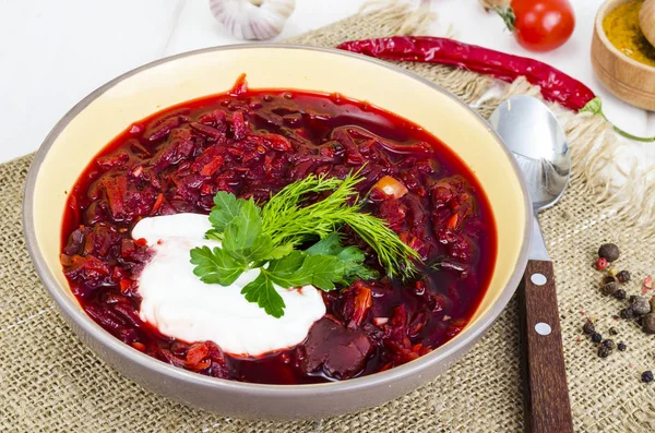 Delicious hot vegetable soup with beetroot, Russian borscht. Studio Photo