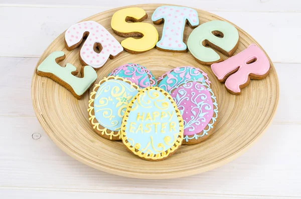 Homemade Easter pastry in shape of letters and eggs on wooden background. — Stock Photo, Image