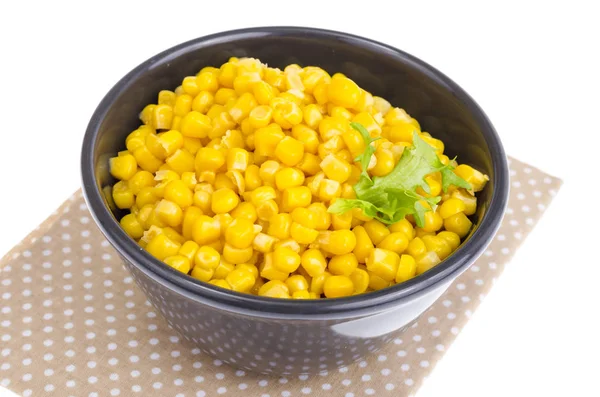 Canned corn in black bowl. — Stock Photo, Image