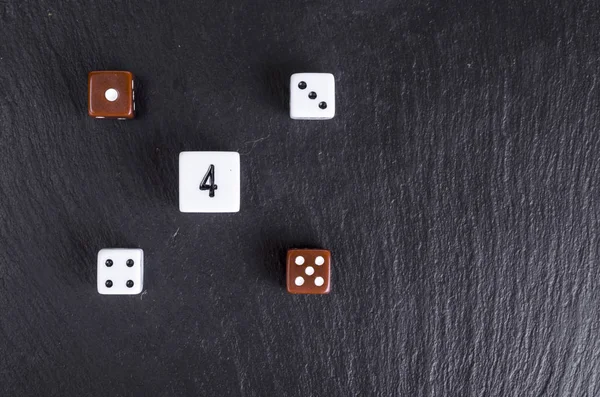 Rolling dices with any number over black background. Casino gambling concept.