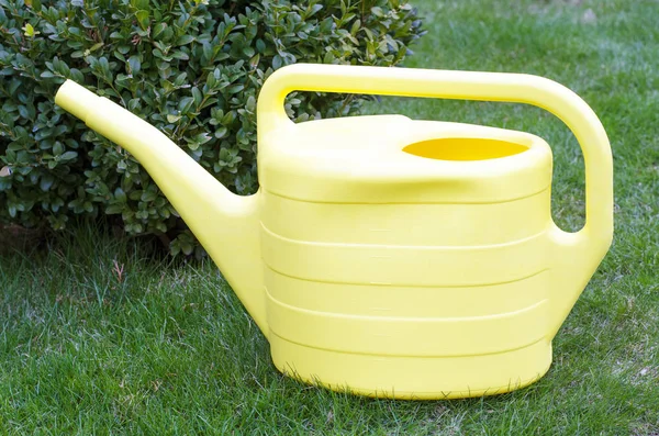 Gul vattnings kanna för vattning växter i trädgården. — Stockfoto