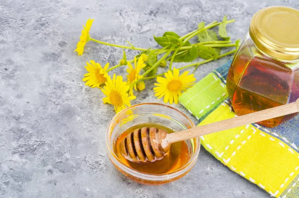 Aromatic flower honey, wild flowers on gray background. — Stock Photo, Image