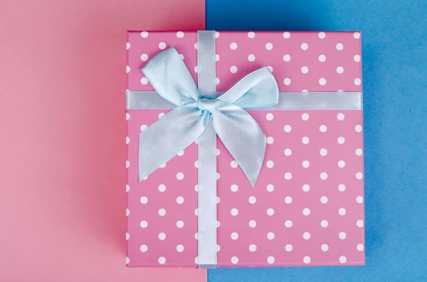 Square box of pink polka dots on bright background