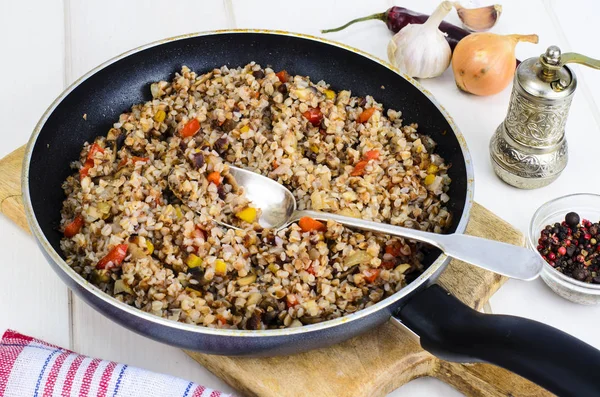 Buckwheat porridge with vegetables in pan — Stock Photo, Image