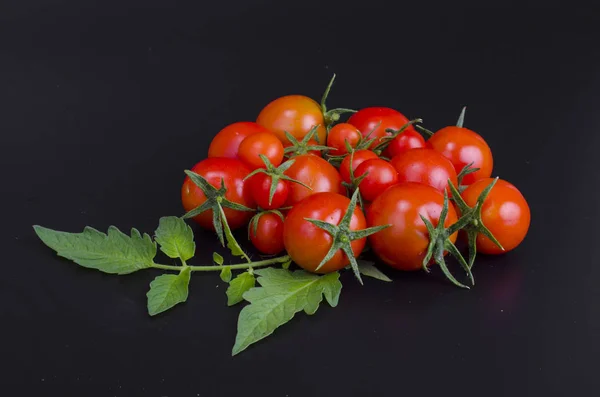 Red ripe cherry tomatoes on black background — Stock Photo, Image