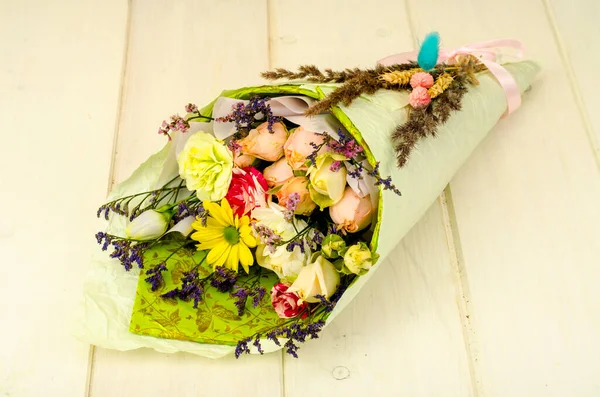 Bouquet Flowers Wrapped Paper White Wooden Table Studio Photo — Stock Photo, Image