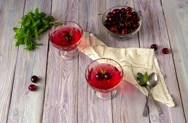 Yazlık, kiraz ve nane bir menekşe, ahşap arka plan yakın çekim üzerinde lezzetli jöle