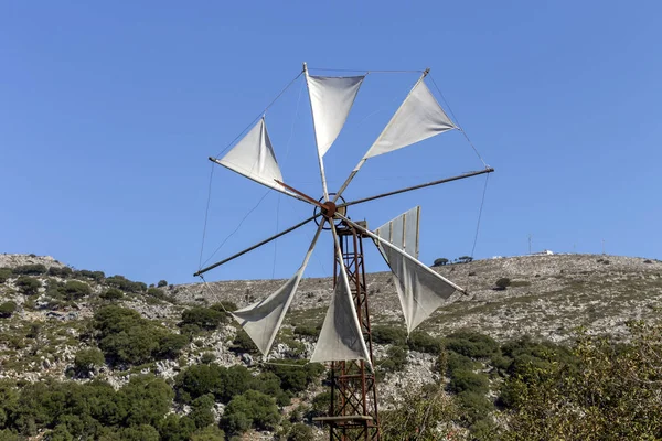 Old, historic, famous, metallic windmills who pump water out of the ground for irrigation of fields on a sunny day (Lassithi area, island Crete, Greece)
