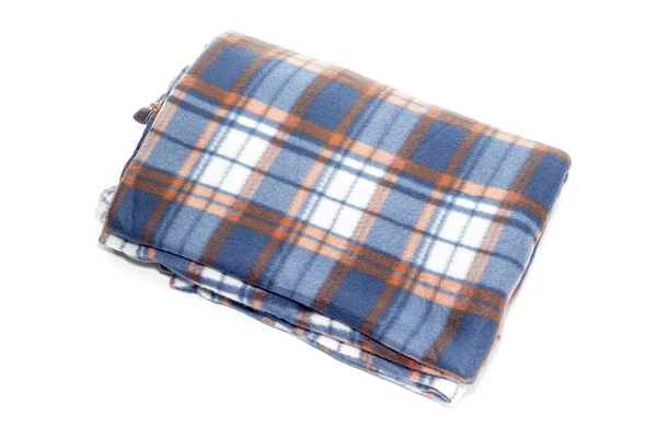 New, plaid fleece blanket on white background close-up