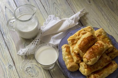 Hazır yemek. Süt bir sürahi ve bardak, kırmızı lahana ile kekler ve yalan bir plaka yakın çekim ahşap bir masa üzerine mantar