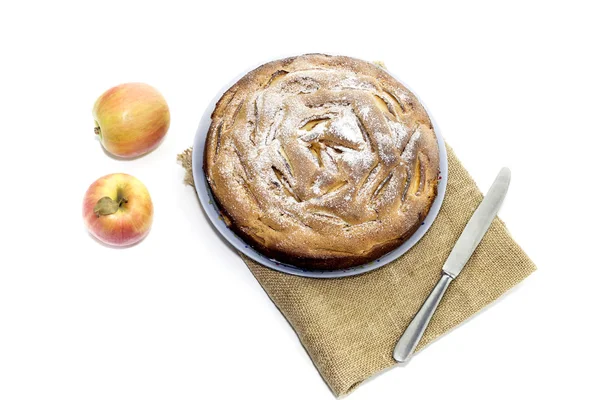 Ready meal. Fresh, ruddy, sweet apple pie on a white background close-up