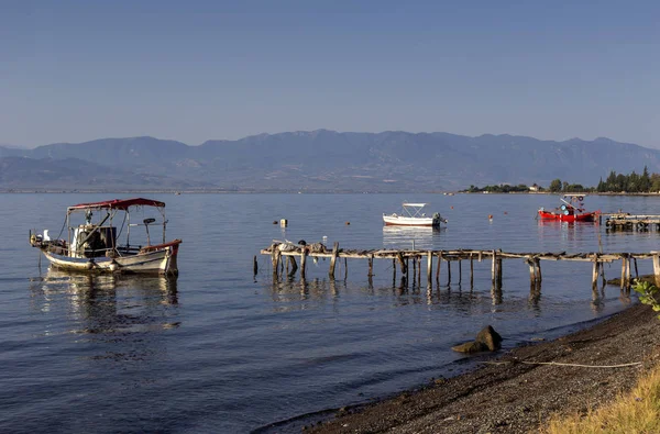 De vissersboten liggen afgemeerd in de buurt van de kust en houten, oude pier — Stockfoto