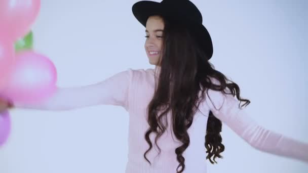 Happy carefree girl plays with balloons at camera on background — Stock Video