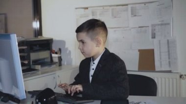 Başarılı çocuk klavyede türleri ve başparmak gösterir. 4k