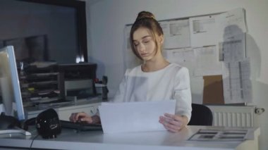 Meşgul kız diyagramları ve ofiste pc çalışır. 4k