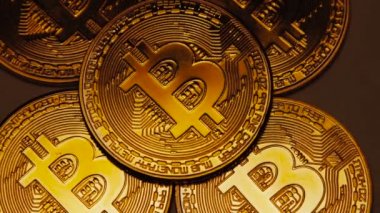 Makro çekim altın bitcoins koyu arka plan üzerinde döndürme