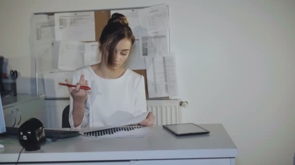 Πολυάσχολη κοπέλα εργάζεται με διαγράμματα και το pc στο γραφείο. 4k — Αρχείο Βίντεο