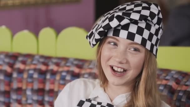 Smiling girl in chief uniform smearing her face with flour at camera — Stock Video