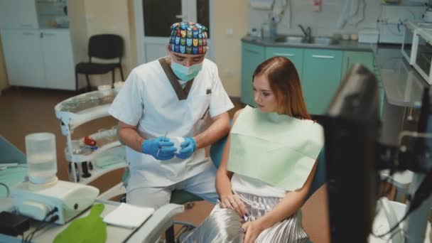 Mooi meisje is in de tandheelkundige kabinet op consultating. 4k — Stockvideo