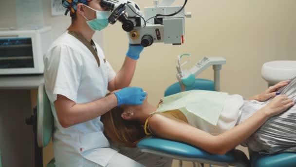The girl is on dental treatment with special intraoral check. 4K — Stock Video