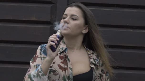 Παθιασμένη γυναίκα κάπνισμα e-τσιγάρων σε εξωτερικούς χώρους — Αρχείο Βίντεο