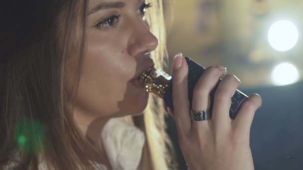 Perfil de chica sexy fumando furiosamente cigarrillo electrónico y vapeo en interiores — Vídeos de Stock