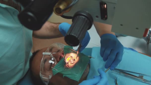 牙医使用显微镜进行治疗。4k — 图库视频影像